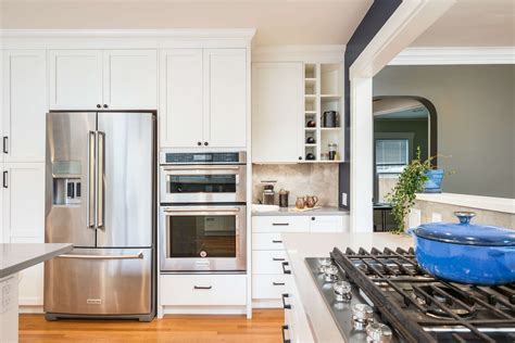 white or stainless steel appliances to match white shaker cabinets|stainless steel kitchen cabinets.